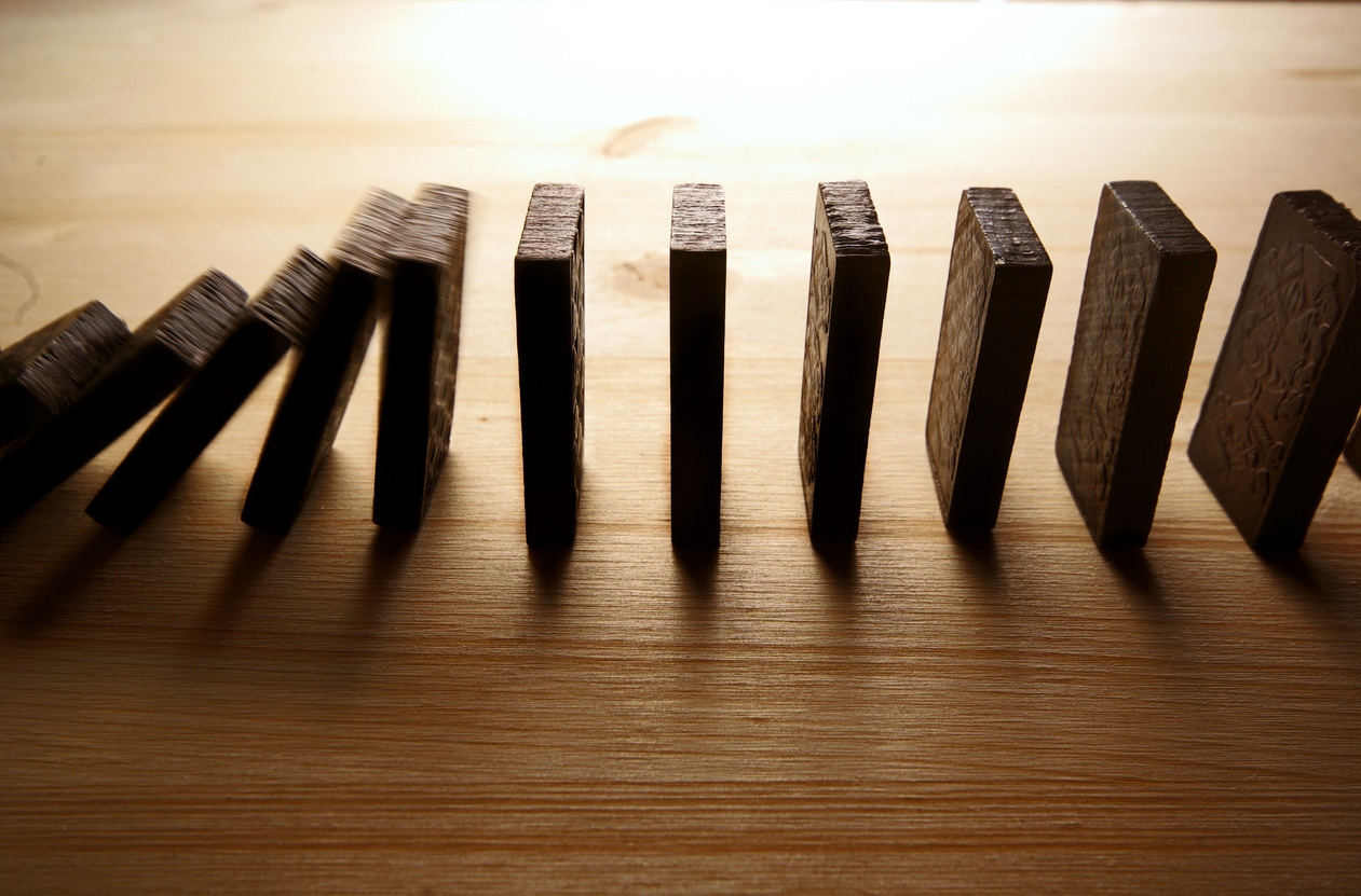 Falling row of dominoes on wooden surfaces