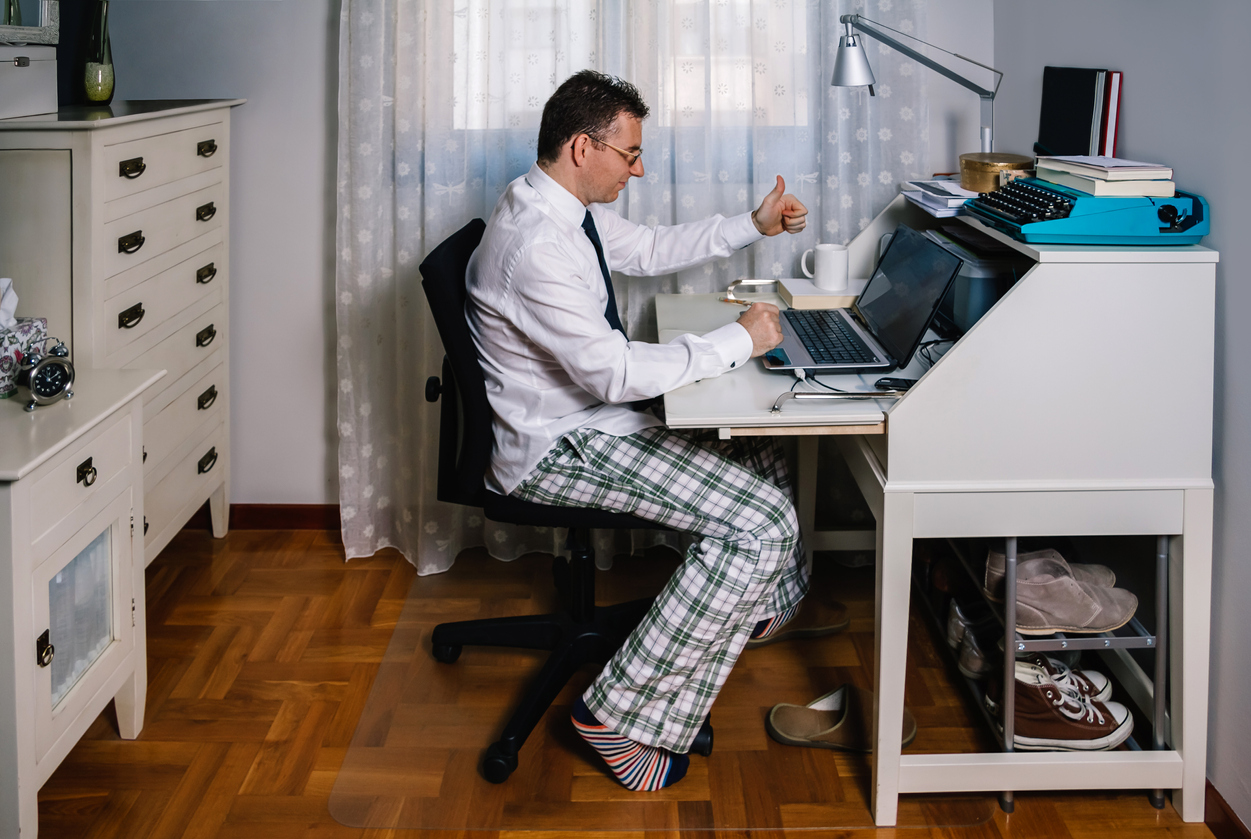 Man teleworking wearing shirt, tie and pajama pants