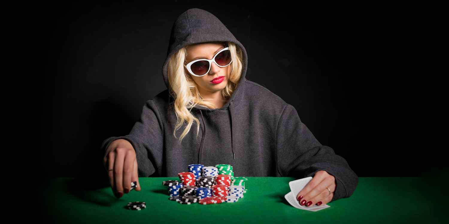 Woman playing cards with poker chips